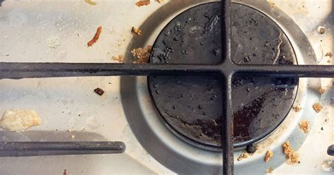 clean gas stove caps